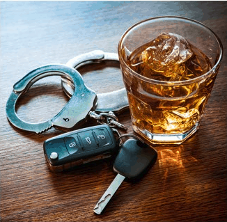 A pair of handcuffs next to car keys and an alcoholic beverage